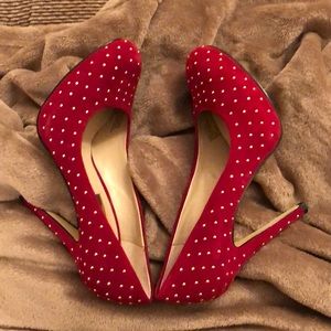 A pair of red gold beaded shoes.